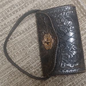 Vintage tooled, distressed saddle leather bag with heavy duty Copper hardware